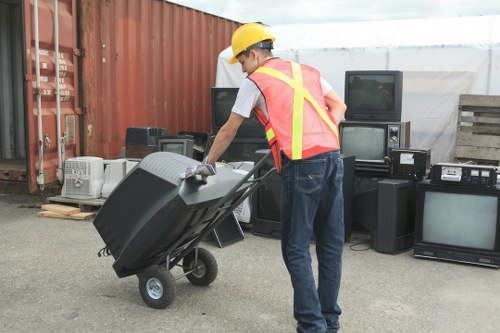 Business staff separating recyclables into labelled containers